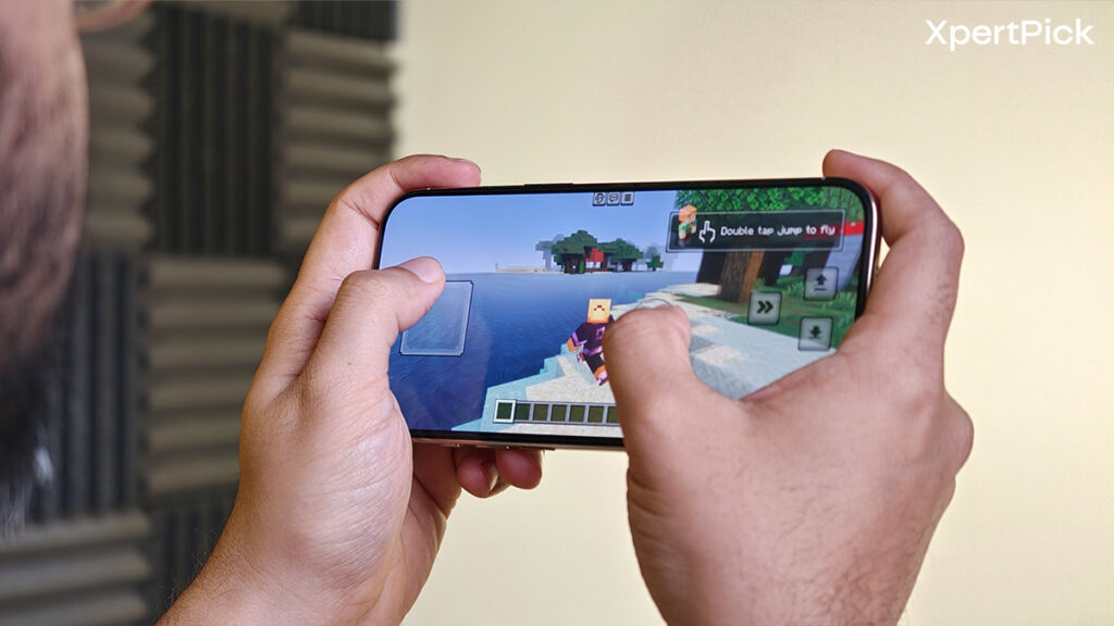 Apple iPhone Air held in landscape orientation while playing Minecraft, demonstrating gaming performance and display responsiveness. (Yetnesh Dubey / XpertPick)