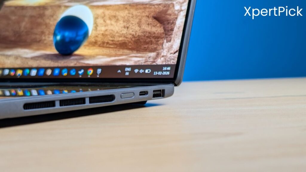 Close-up of the left-side ports and ventilation on the ASUS ZenBook Duo laptop, showing USB-C, USB-A ports and cooling vents on a wooden desk. (Source: Yetnesh Dubey / XpertPick)