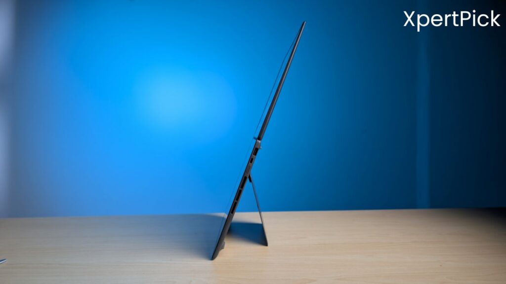 Side profile of the ASUS ZenBook Duo showing its slim dual-screen design and built-in kickstand supporting the laptop on a wooden desk. (Source: Yetnesh Dubey / XpertPick)