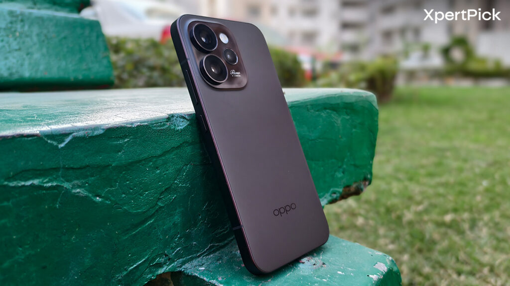 Oppo Reno15 Pro Mini back design shown at an angle highlighting matte rear panel and triple camera module placed outdoors (Source: Yetnesh Dubey / XpertPick)
