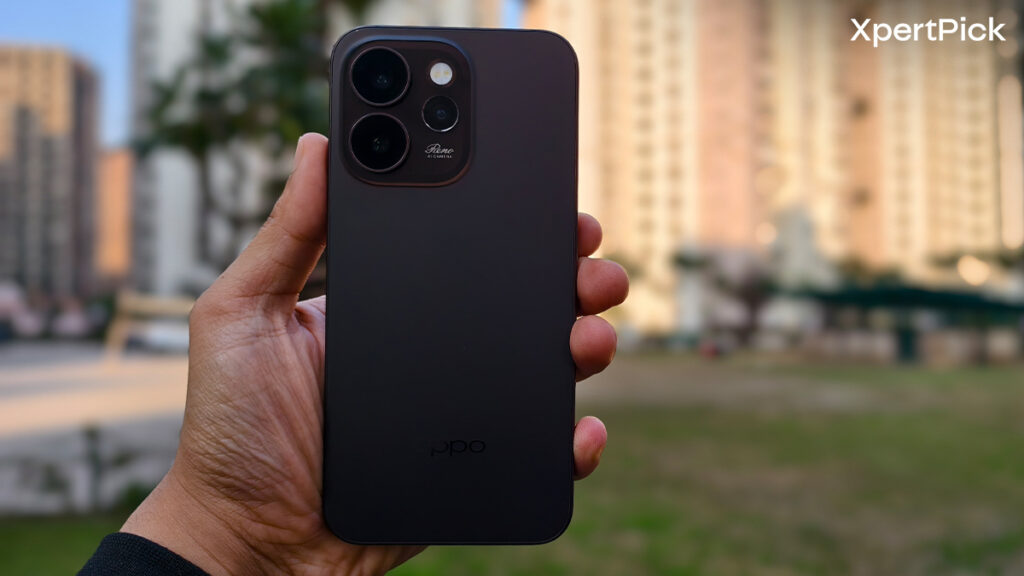 Oppo Reno15 Pro Mini back design showing matte rear panel and triple camera module while being held in hand outdoors (Source: Yetnesh Dubey / XpertPick)