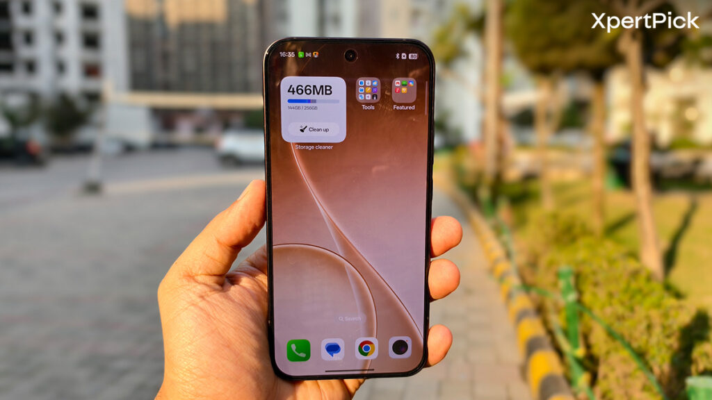 Oppo Reno15 Pro Mini front display showing home screen and punch-hole front camera while being used outdoors in daylight (Source: Yetnesh Dubey / XpertPick)